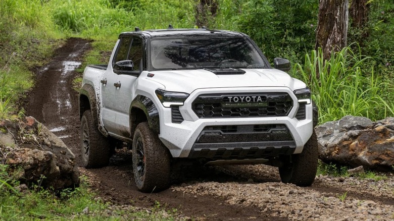 Toyota Tacoma driving through mud