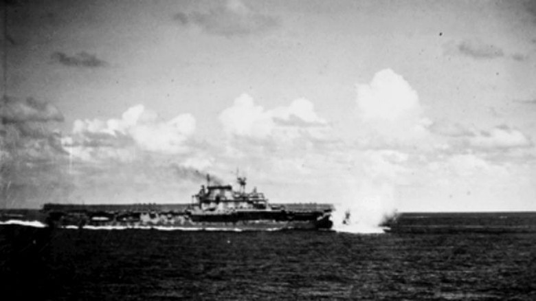 USS Hornet (CV-8) heels sharply to starbord as a Japanese bomb nearly misses her