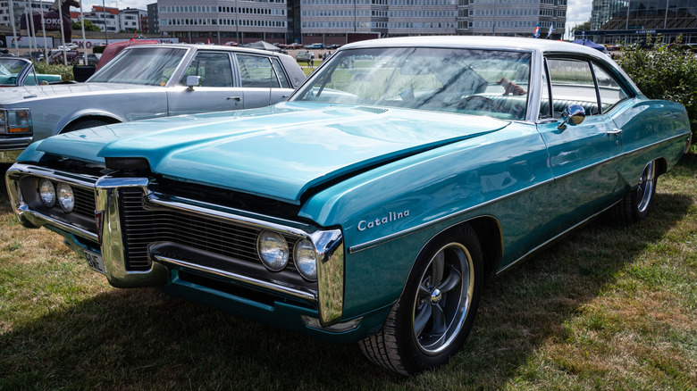 A blue 1968 Pontiac Catalina parked across a lawn