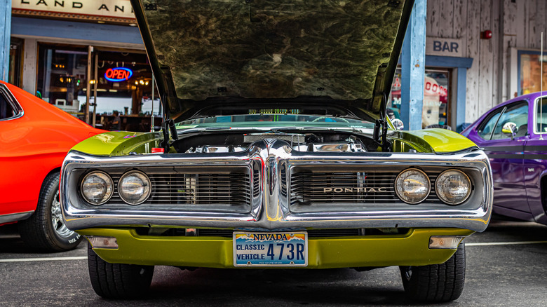 A 1968 Pontiac vehicle with its hood up