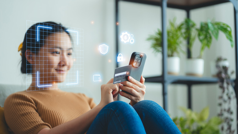 woman using iPhone Face ID with a graphic of a grid over her face