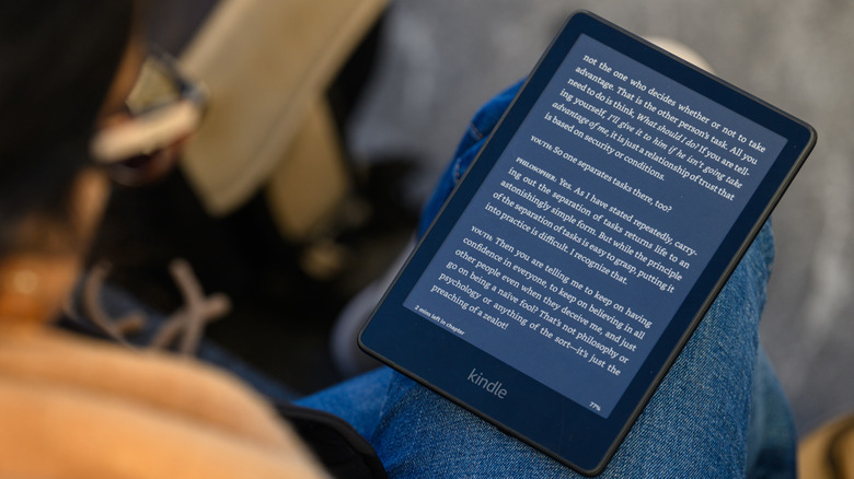 A Kindle sitting on someone's leg