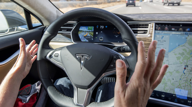 Hands off Tesla steering wheel.