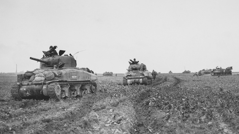 Sherman tanks riding across landscape