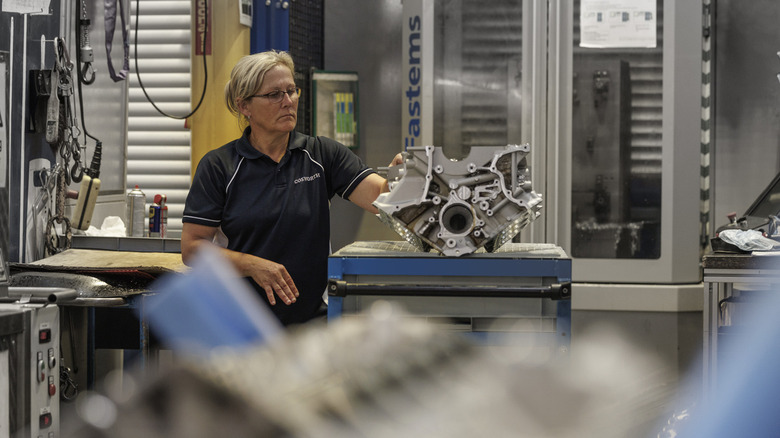 woman working on Cosworth engine