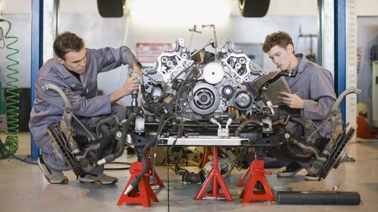 Two men doing engine maintenance