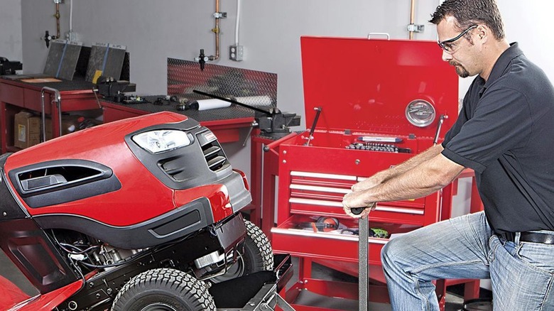 Man using a Harbor Freight mower 