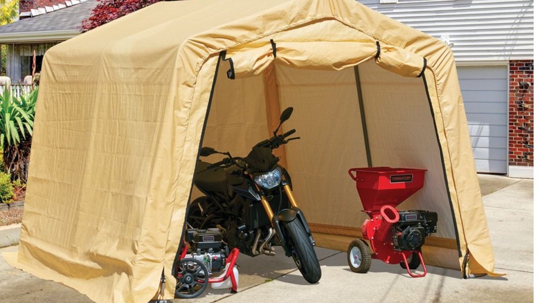 A motorcycle inside a portable shed