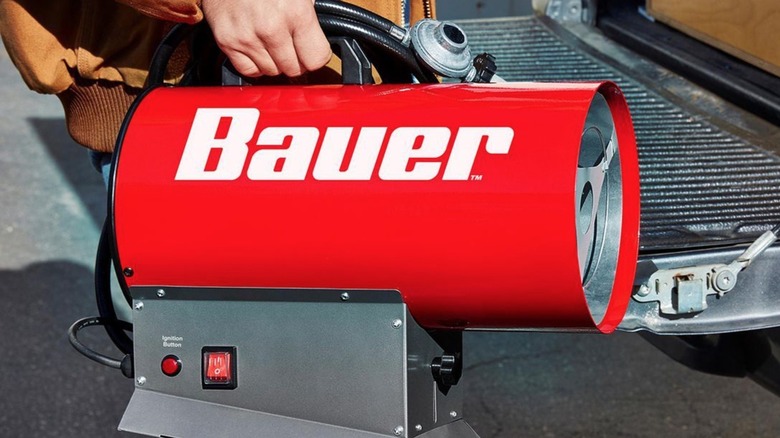 Person carrying a Bauer Torpedo Heater