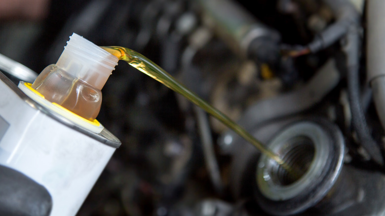 Pouring oil into engine