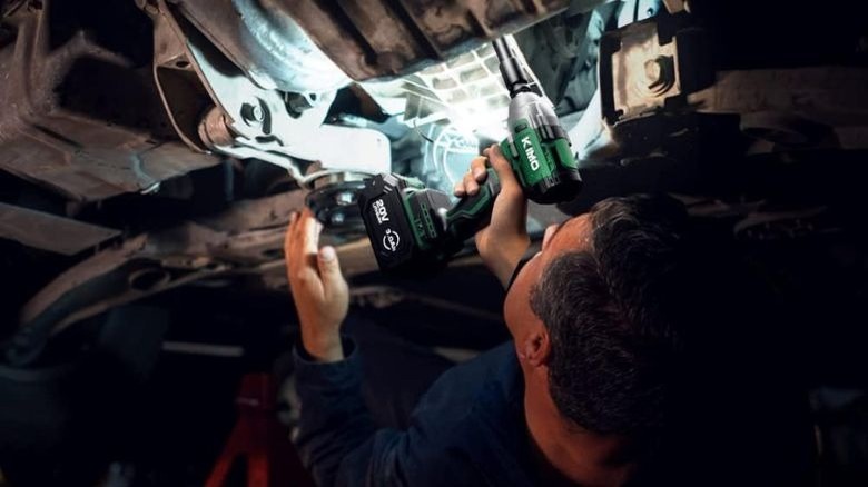 Mechanic working on a car using a Kimo tool