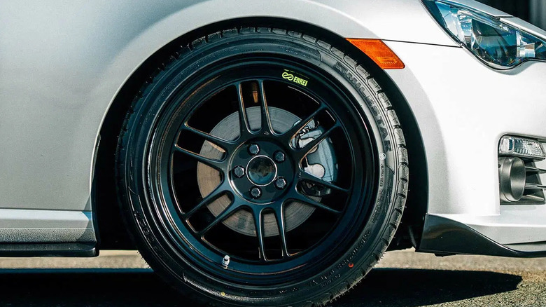 A close-up shot of a Milestar-branded tire on a white passenger car