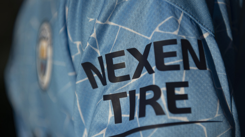 The Nexen Tire brand printed on the sleeve of an athlete's shirt