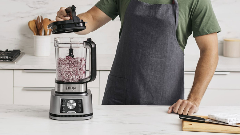 man using a Ninja blender