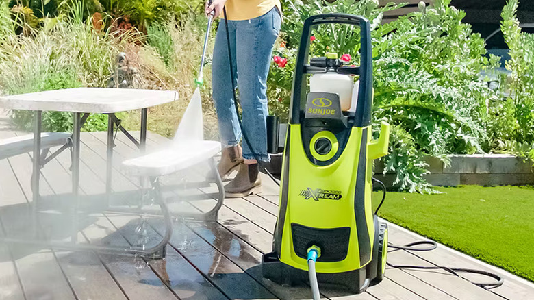 person using sun joe pressure washer