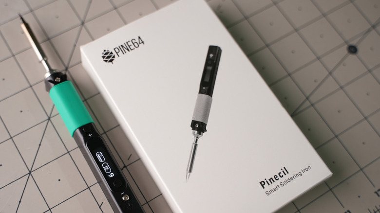 Pinecil smart soldering iron place beside its packaging box