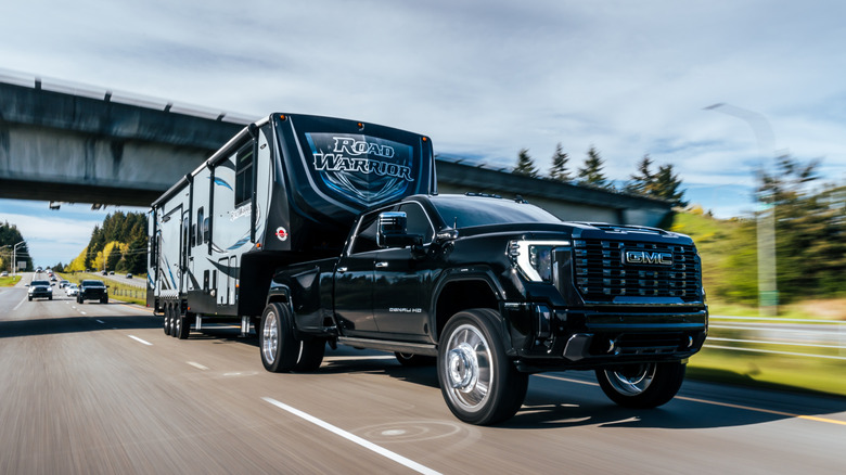 GMC Sierra pulling large trailer on highway