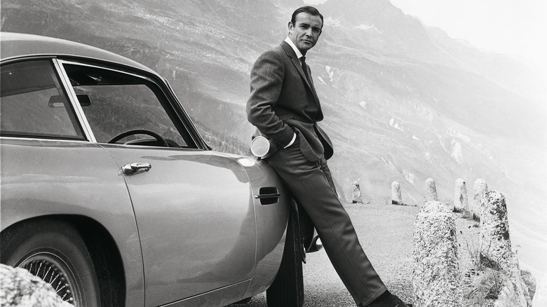 Rear 3/4 shot of Aston Martin DB5 and Sean Connery