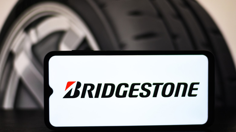 Bridgestone logo on phone in front of tire