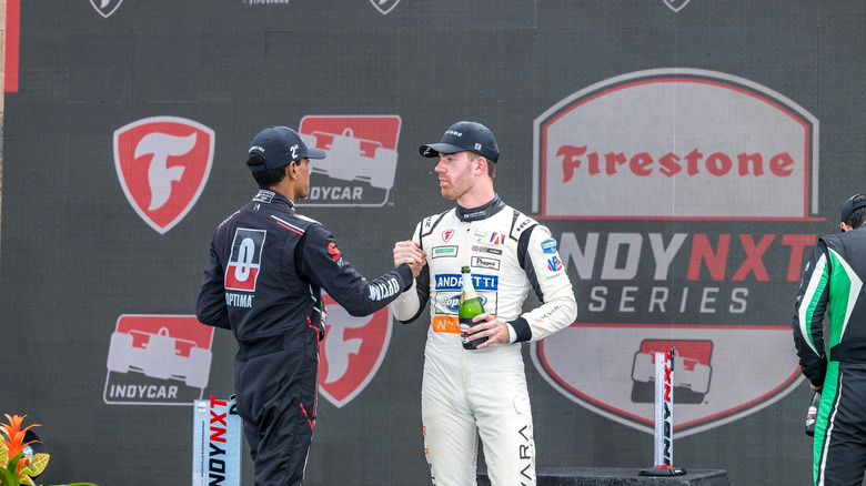 Drivers shaking hands at IndyCar podium ceremony