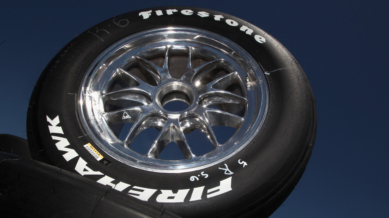 Firestone Firehawk tire against blue background