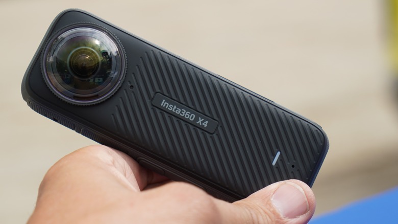 Insta360 X4 camera being held on display.