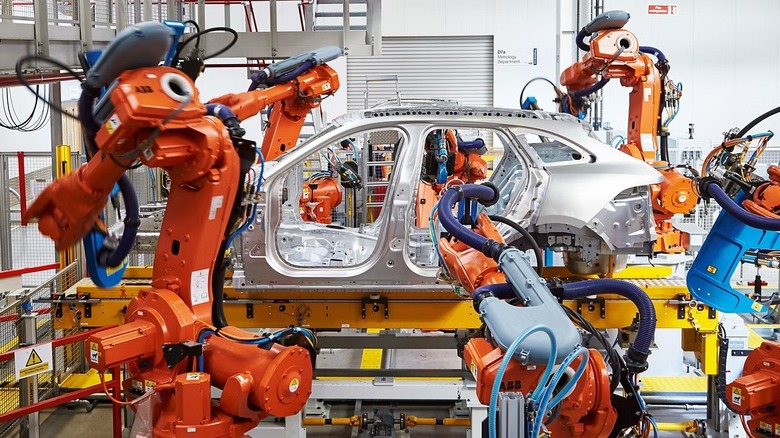 Machines building a Jaguar body in the manufacturing plant