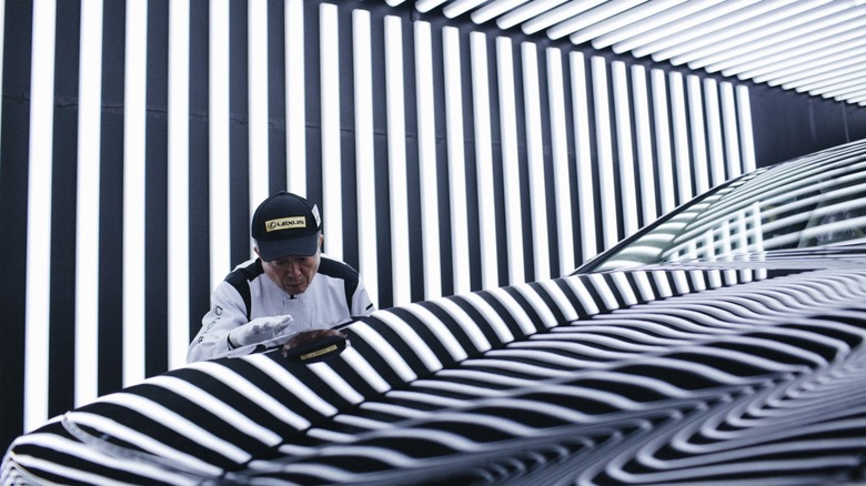 Lexus Takumi master craftsman inspecting vehicle