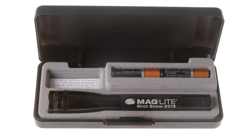 A Maglite flashlight in a case with batteries