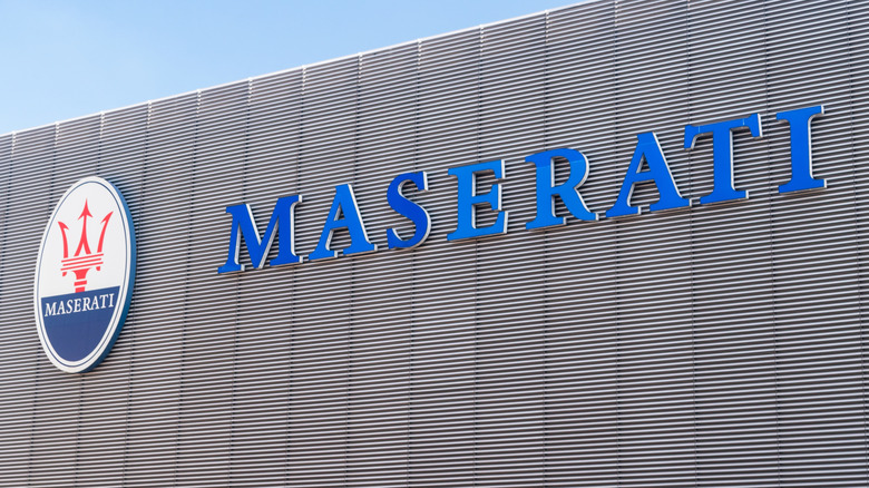 The Maserati logo on the side of a building.