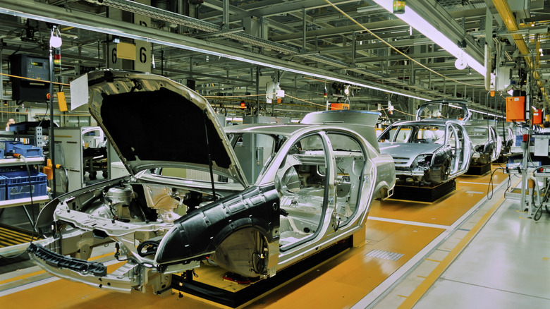 Multiple car frames being assembled at a manufacturing facility