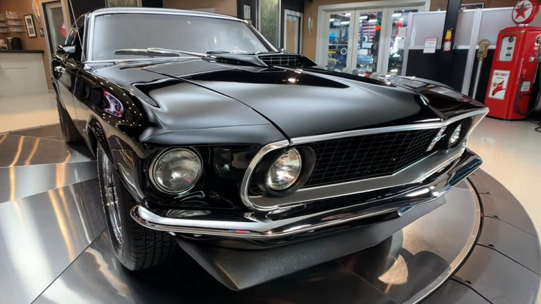 A black 1969 Ford Mustang on display.