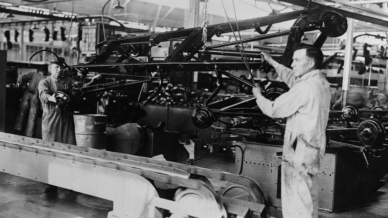 Henry Ford with car-assembly equipment