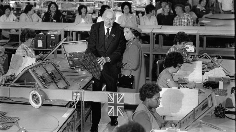 Queen Elizabeth II is given a tour of Hewlett-Packard by founder David Packard during her West Coast tour of the United States accompanied by Prince Philip on March 5, 1983 in Palo Alto, California. They are surrounded by Hewlett Packard employees.