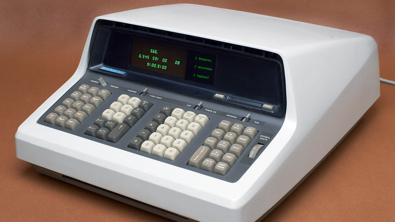 Hewlett-Packard's HP9100A desktop calculatorwith multiple rows of keys and a display screen showing green text. It has a sloped front panel and a compact, angled shape, typical of late 1960s computing equipment