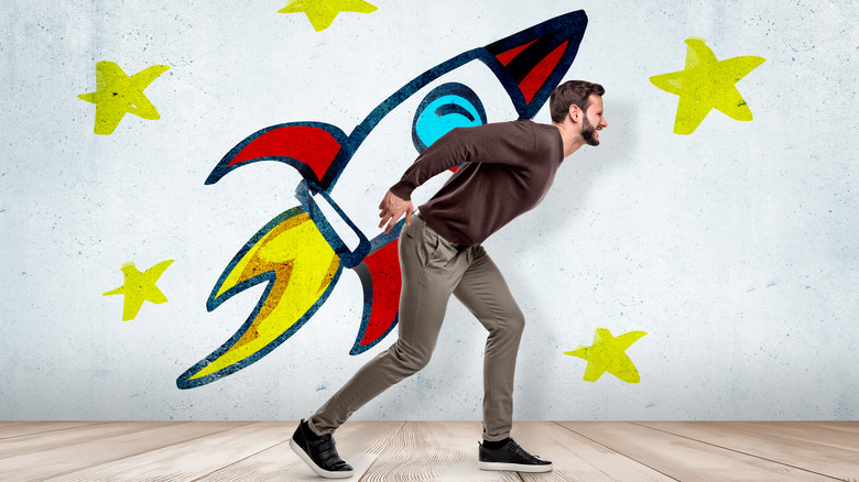 person carrying illustrated rocket ship on back