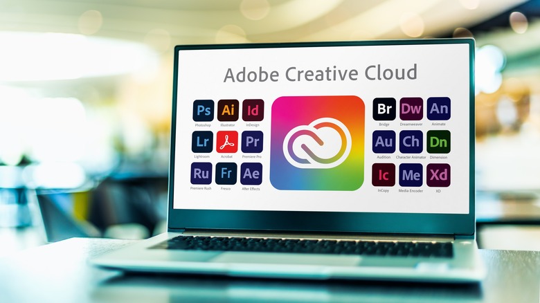 Adobe Creative Cloud product icons on a laptop display