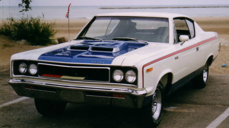 An AMC Rebel Machine car parked by the beach