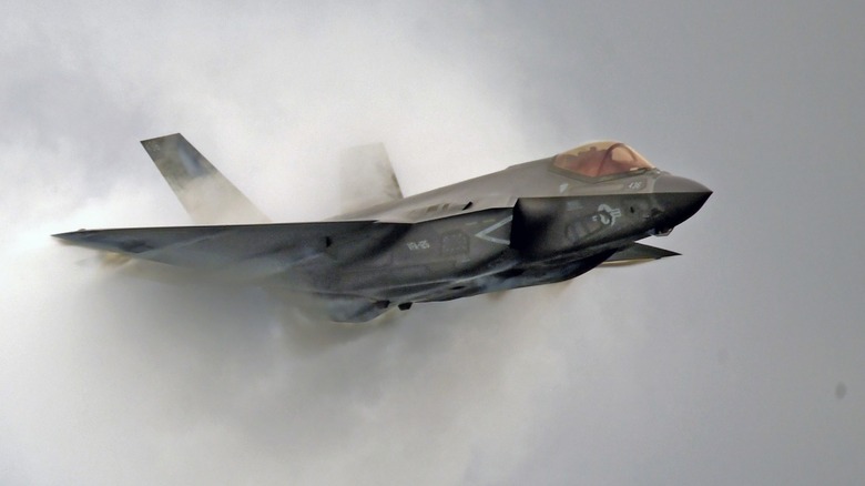 F-35 military jet with smoke coming out of the back