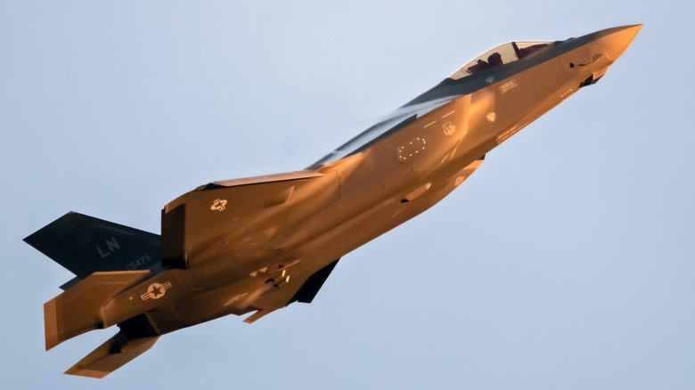 F-35 jet flying upward in the sky