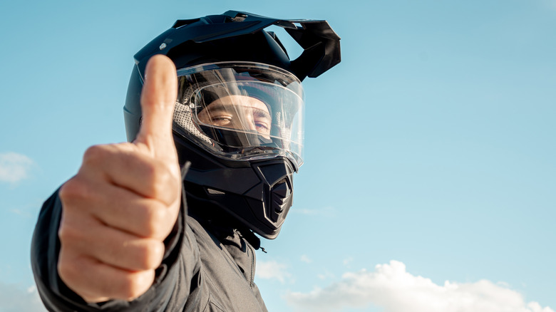 Rider with dual-sport helmet