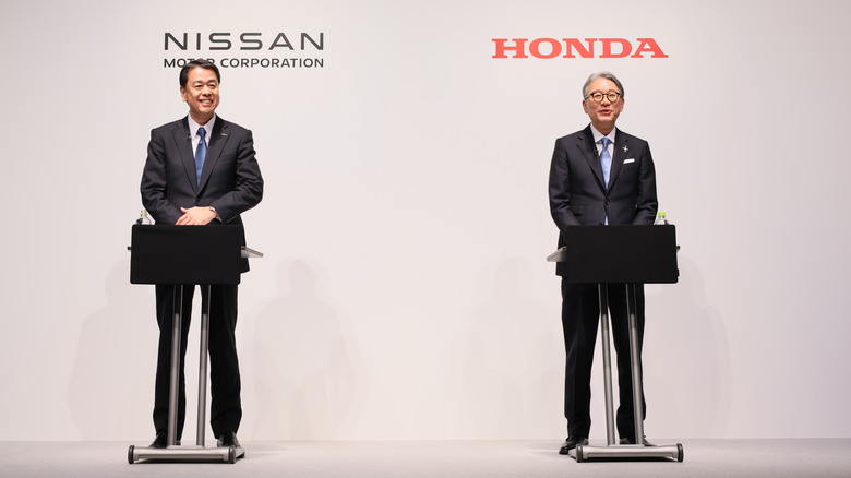 Executives from Honda and Nissan at a press conference.