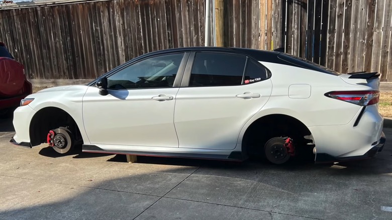 A TRD Camry In White After Its Wheels Were Stolen