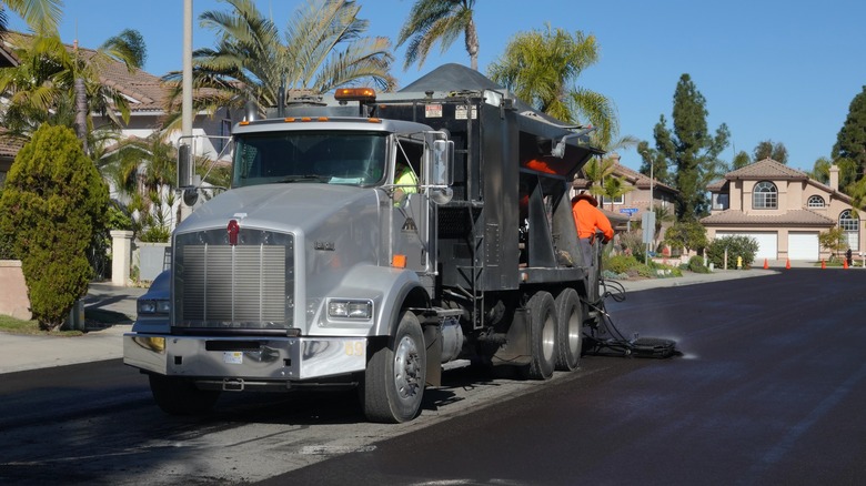 Truck coating road in oil