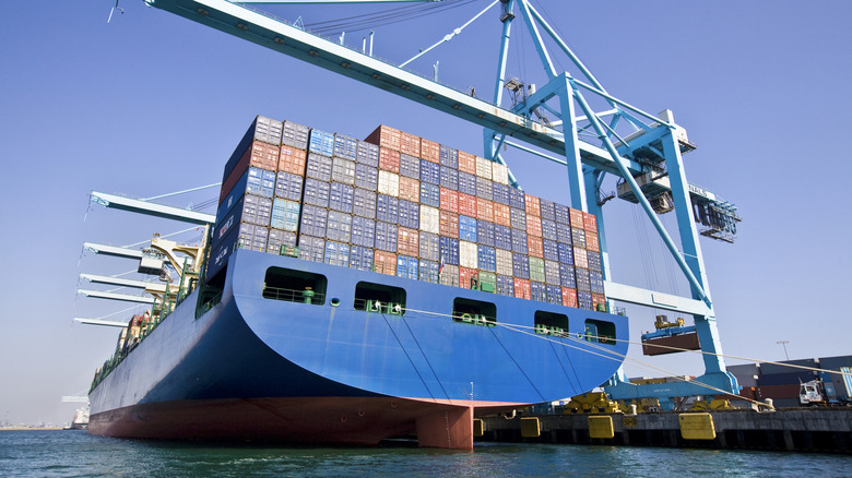 Large cargo ship with red hull