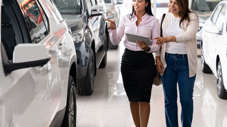 Salesperson showing a customer a vehicle