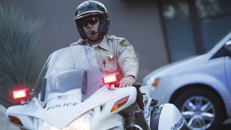 Police officer on motorcycle with flashers on