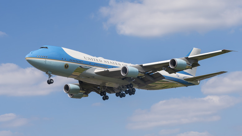 Air Force One in sky with landing gears down