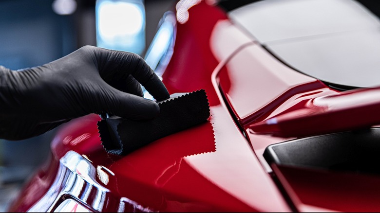 Applying wax to car by hand