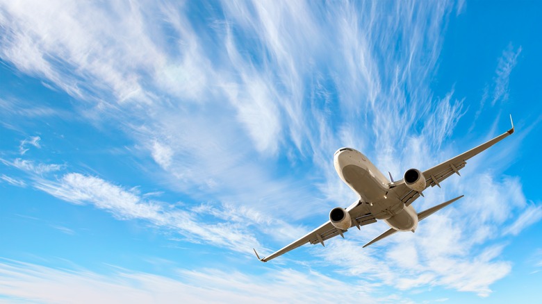 White passenger plane flying in sky